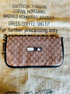 GUCCI  x MLB collab canvas pouch features the iconic GG monogram pattern